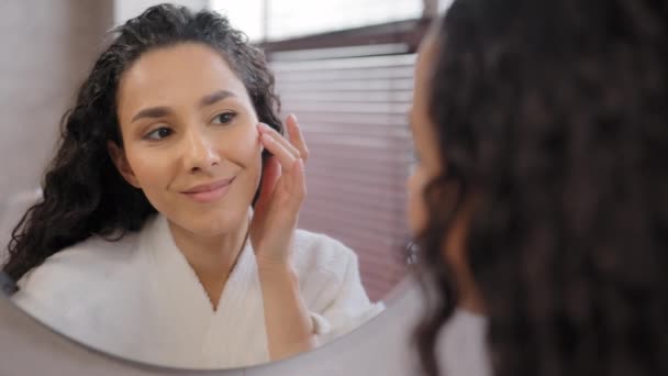 Young Attractive Woman Bathrobe Looks Mirror Bathroom Touches Moisturized Face — Video Stock