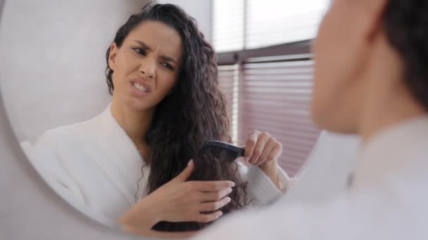 Close Young Woman Looking Mirror Combing Hair Bathroom Annoyed Sad — стоковое видео