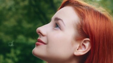 Close up profile female face young caucasian pretty beautiful woman girl redhead teenage dreamer posing outside model with perfect clean skin short stylish hairstyle natural day make up beauty concept