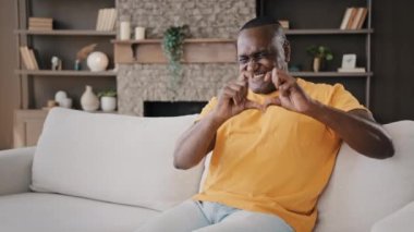 African affectionate lover man gentle american adult senior volunteer make heart shape with fingers expressing healthy human feels charity love romantic valentine symbol for beloved sweetheart at home
