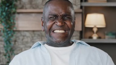 Portrait of annoyed african american adult man angry furious senior elder businessman shouts NO covers ears with hands much noise feels panic attack mad furious about loud music disturbing noisy sound