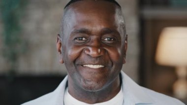 Portrait happy positive african american man intelligent older businessman father adult friendly person. Close up male face gaze looking at camera smiling cheerful expressing toothy smile good emotion