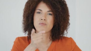 Close-up female portrait African American angry mad serious woman with curly hair looking at camera sternly waving shaking finger scolding forbid disapproval sign expressing disagreement irritation