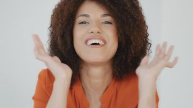 Portrait close-up enthusiastic female face girl shocked lady with curly hair woman smiling looking at camera opens mouth says wow delight shock surprise win victory reaction wonder amazed expression