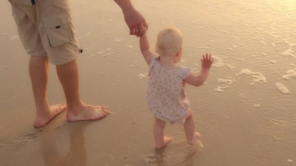 Unrecognizable Caucasian Caring Father Holding Baby Daughter Toddler Hand Stepping — Stockvideo