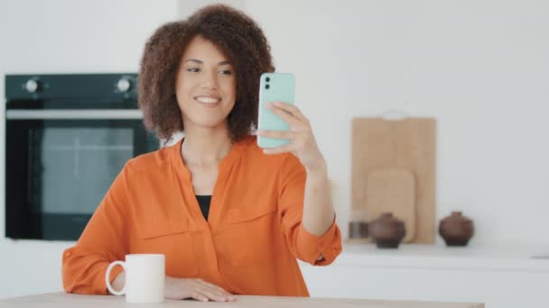 African Millennial Woman Curly Hair Girl Orange Blouse Female Vlogger — стоковое видео