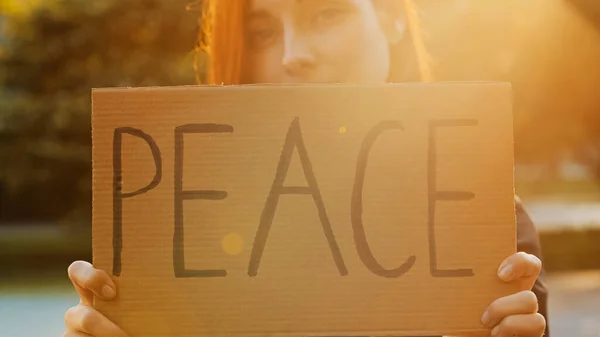 Close Female Hands Hold Cardboard Written Word Peace Symbolic Banner — Stock Photo, Image