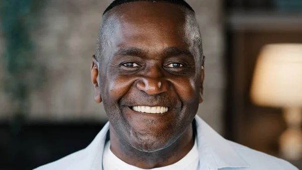 Portrait happy positive african american man intelligent older businessman father adult friendly person. Close up male face gaze looking at camera smiling cheerful expressing toothy smile good emotion