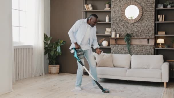 Adult African American Homeowner Cleaner Washing Floor Parquet Surface Vacuum — Video Stock
