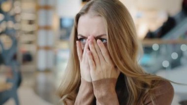 Close up upset young girl sad unhappy 20s caucasian woman feel stress pressure misunderstanding feeling of helplessness problems at work cover face with hands bad news difficult period of life concept