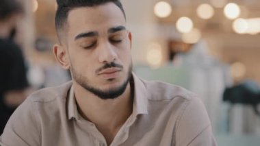 Portrait young sad hispanic man make difficult decision suffering headache unhappy depressed arab unhealthy guy feeling fatigue migraine stressful condition hard choice chronic fatigue problem at work