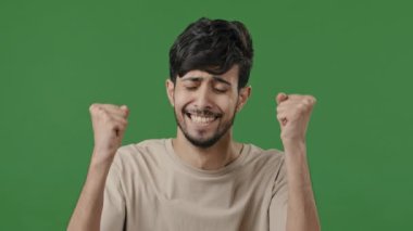 Happy surprised hispanic man looking at camera rejoice victory luck feel happiness triumph emotional young arab guy excited amazing news portrait shocked enthusiastic male celebrate victory in studio