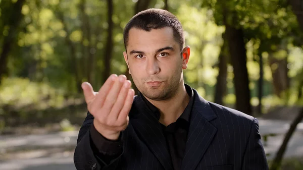 Caucasian businessman with strong serious eyesight adult confident man wear formal black suit pointing finger at camera hey you come here inviting hand gesture welcome symbol calling to show something