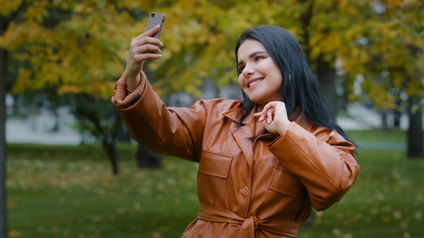 Close Young Hispanic Woman Stands Autumn Park Holding Phone Hand — Zdjęcie stockowe