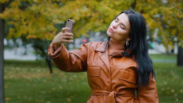 Close Young Hispanic Woman Stands Autumn Park Holding Phone Hand — Zdjęcie stockowe