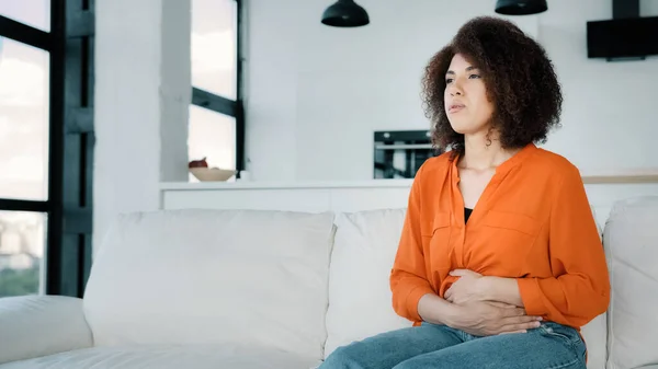 Sad African Woman Home Curly Hair Ill Girl Sitting Sofa — Zdjęcie stockowe