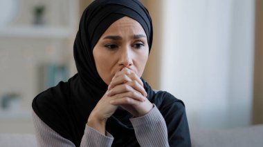 Upset sad girl in hijab sit alone get bad news feel depressed frustrated muslim woman suffering from illness worried about unresolved problems feeling sorrow grief hard divorce need psychological help
