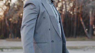 Close-up mature african american happy businessman male shopper consumer walking down street carrying gift bags puts shopping in car bought gifts for holiday pleased enjoys with discount sale purchase