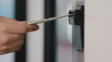 Male hand putting money banknote in entry to ATM error of banking machine bank transaction problem financial unsuccessful payment system operation with electronic money in auto tech cash dispenser