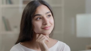 Portrait dreamy arabic smart woman thoughtful calm girl meditating dreaming about future plan remembers pleasant moments search inspiration creative ideas enjoy peaceful mental relaxation daydreaming