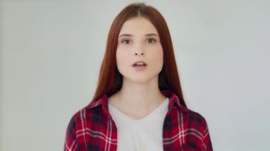 Close up surprised shocked female face excited 20s millennial young woman girl winner amazed with victory successful triumph feels shock says wow positive reaction delight emotion holds head by hands