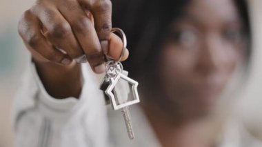 Out focus young woman realtor sales agent holding bunch apartment keys advantageous offer affordable housing happy girl homeowner demonstrating buying renting new house home on mortgage focus on key