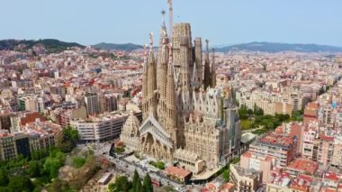 Panorama aerial view flying drone shot over famous Spanish city Barcelona tourism traveling place top outside exterior facade catholic religious church La Sagrada Familia cathedral temple in Spain