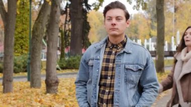 Loving caucasian young woman girlfriend wife closed eyes beloved boyfriend make surprise for man gives red gift box with gold ribbon present for valentines day birthday in autumn park couple kissing