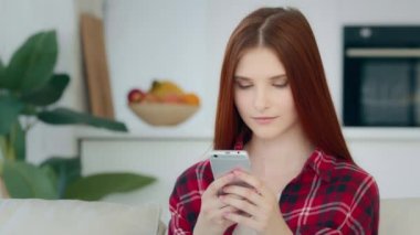 Surprised joyful female winner teenage user freelancer caucasian redhead lucky girl woman browsing online clothing shop win discount in internet mobile app rejoice victory read good sms on smartphone