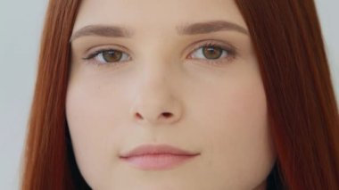 Close up sad unhappy woman face young girl redhead caucasian girl teen blink dark eyes depression facial emotion desperate looking at camera suffering from bullying racism experiencing problem sadness