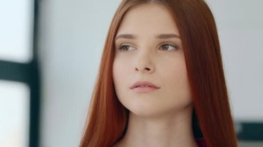Female serious female 20s portrait indoor alone sad calm confident caucasian european appearance redhead woman student girl model with strong dark eyesight looking at camera bullying feminism equality