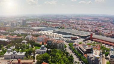 Aerial view beautiful popular tourist city Madrid Atocha train station largest railway station in Spain historical buildings famous square attraction slow motion from above landscape panorama Europe