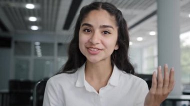 Headshot young positive woman business agent sales consultant makes presentation looking at camera talking using webcam sells product advertises service successful businesswoman blogger recording vlog