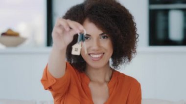 Portrait African exited woman looks at camera showing bunch keys celebrates success buying new home. Euphoric lady gets real estate opportunity rejoices apartment selling property dwelling relocation