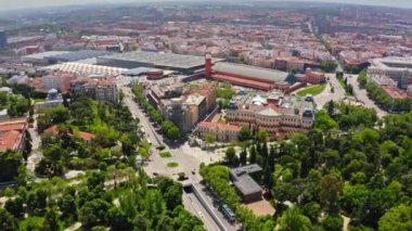 View from above beautiful busy city with historical buildings busy traffic intersection famous Atocha train station biggest railway station in Madrid capital of Spain beautiful cityscape modern city