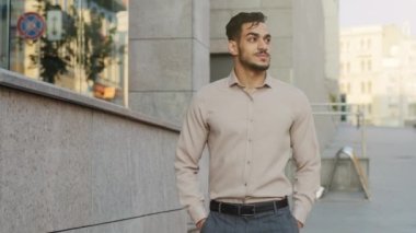 Confident bearded guy in formal clothes professional specialist boss leader male entrepreneur man employee businessman walking in city stepping going near building of creative company looking around