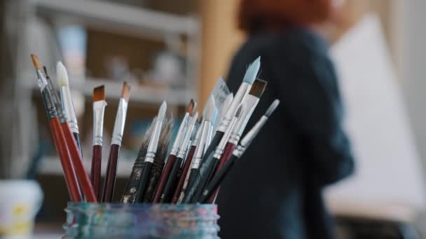 Closeup Woolen Fluffy Paintbrushes Stand Glass Jar Art Studio Background — Stockvideo