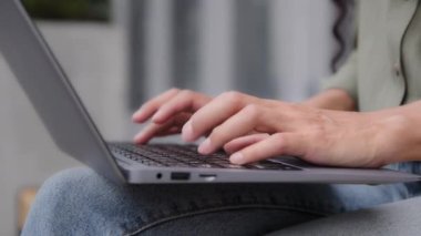 Closeup female hands unrecognizable businesswoman professional user worker writer freelancer using computer app typing laptop notebook keyboard outdoors in city outside working online with pc software