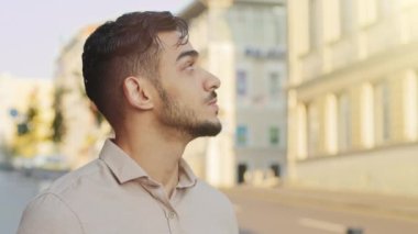 Close up pensive male tourist in old city looking on historical buildings pensive dreamy Hispanic man bearded businessman outdoors looks around wait taxi searching road way thinking thoughtful face