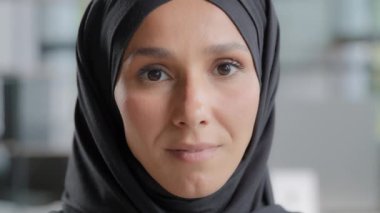 Female portrait close-up arabic female face attractive serious muslim woman in hijab with natural makeup positive smiling islamic lady model looking at camera with carefree expression posing indoors