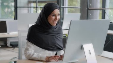 Excited arab businesswoman feeling winner celebrating success rejoicing in victory looking at computer screen winning online video game overjoyed girl gets good news about promotion or great result