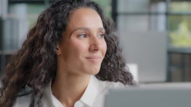 Close-up relaxed satisfied hispanic woman sitting in office enjoying pleasant music carefree businesswoman taking break from work listens to favorite audio track resting slowly dancing in workplace