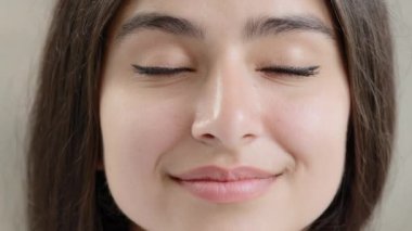 Close up detailed human female face body part young arabian turkey beautiful brunet model woman girl pretty gorgeous lady with thick brows dark eyes black eyeliner natural makeup perfect clean skin