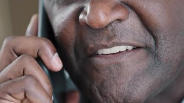 Half male face close up lips toothy white smile with healthy teeth happy smiling man talking phone answer call has mobile conversation talk remote virtual distant communication with smartphone cell