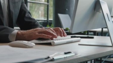Closeup male hands unrecognizable worker programmer Caucasian man in formal suit hacker programmer manager businessman working online browsing chatting in network typing on keyboard computer in office