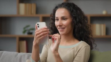 Funny amazed surprised Caucasian Hispanic 30s woman customer with phone looking at mobile screen read good unexpected news in smartphone winning bid getting ecommerce shopping offer discount online