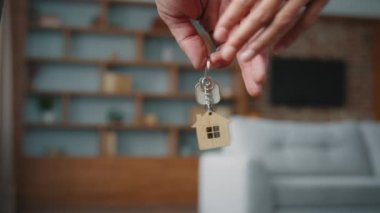 Unrecognizable Caucasian married couple spouses owners with key from buying house receiving mortgage loan bank credit closeup female and male hands holding bunch of keys from new apartment real estate