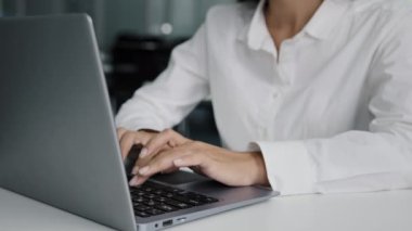 Close-up female hands typing on laptop young businesswoman working in office writing report using computer application checking email writes electronic message communicates with client in social chat