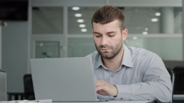 Serious focused executive businessman working on laptop communicating with colleague via video call discussing work plan professional office manager consulting client at online conference using webcam