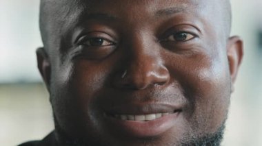 Handsome african american male face plus size happy smiling man teacher employee worker team leader businessman professor adult guy with dark skin healthy sight looking at camera posing indoor office